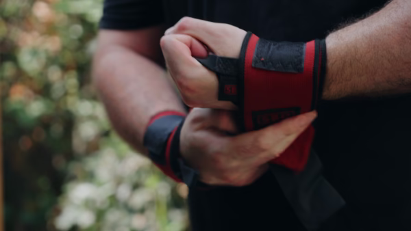 Man putting on power lifting gear