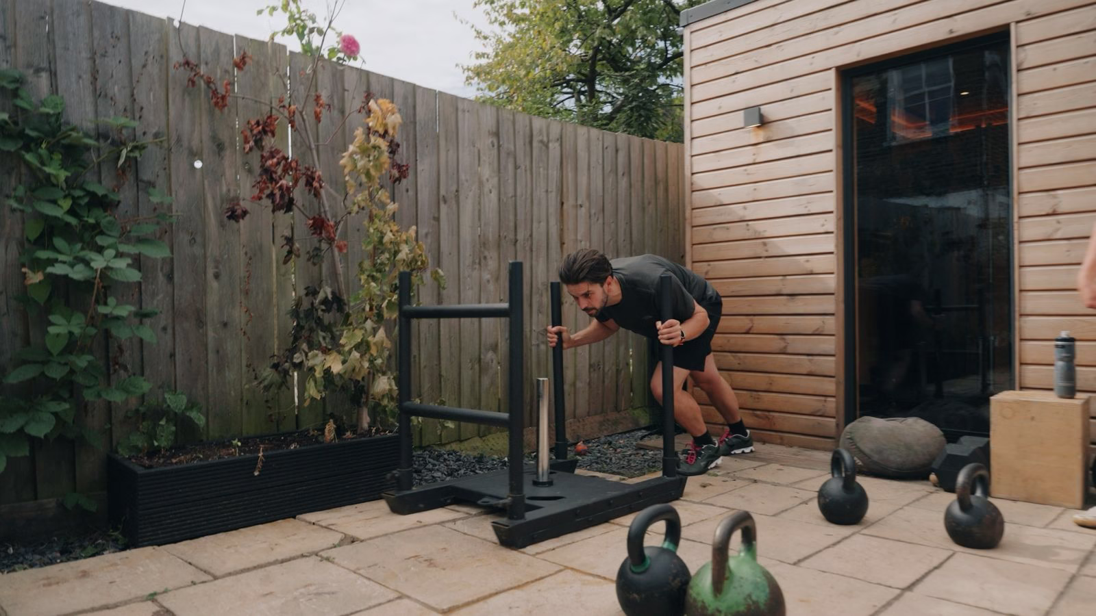 Man strength training with equipment outdoors